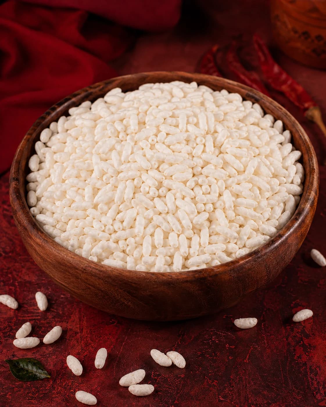 Wooden bowl of plain white puffed rice before roasting
